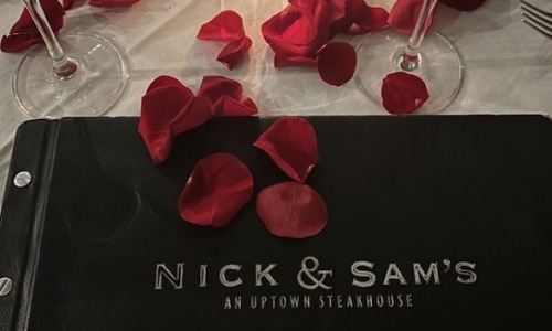 A Perfect Celebration - red rose petals on the table pic by Taylor K. Feb 2022 on Yelp